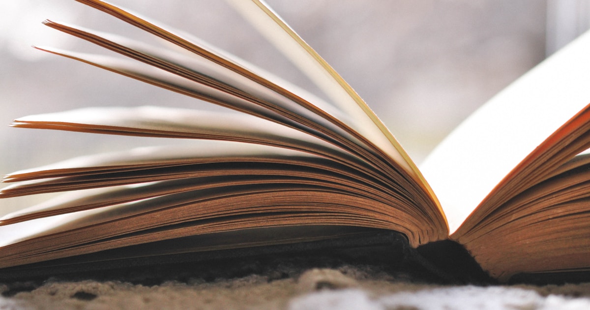 an open book sitting on top of a carpet