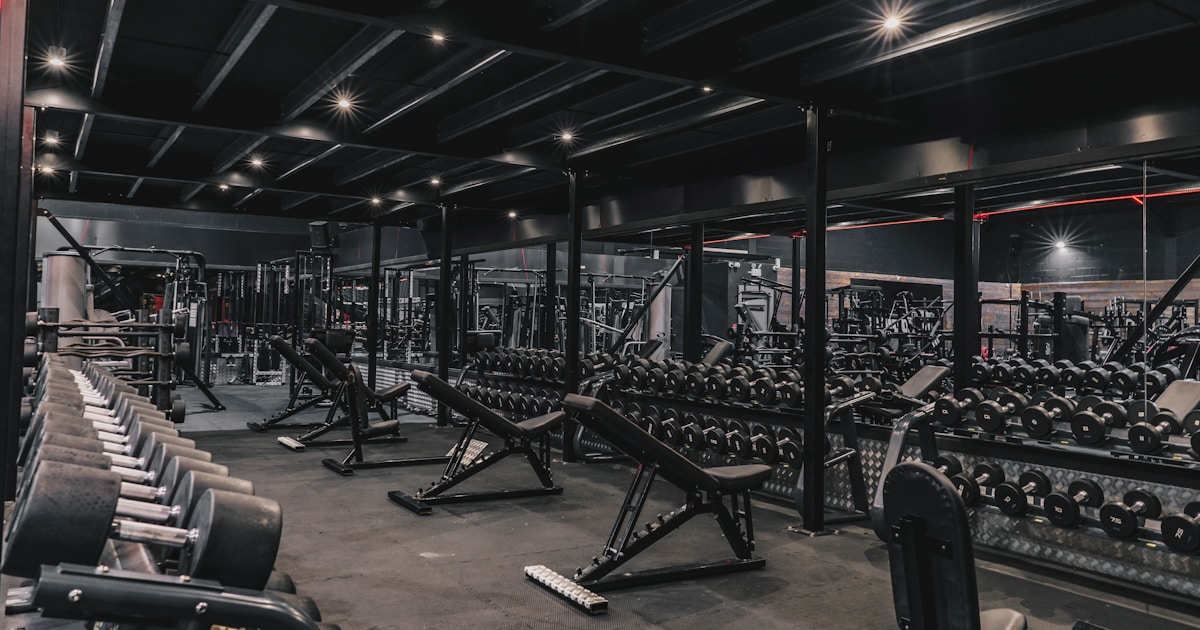 a gym filled with lots of machines and weights