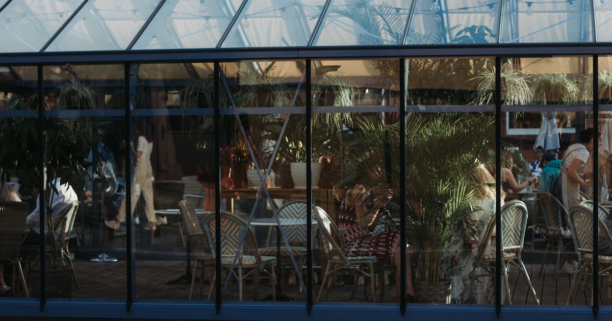 a group of people sitting at a table outside of a building