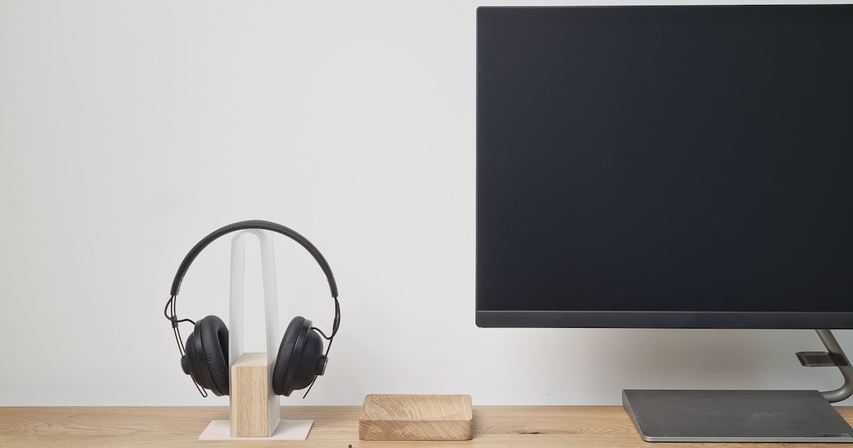 black and silver headphones on brown wooden table