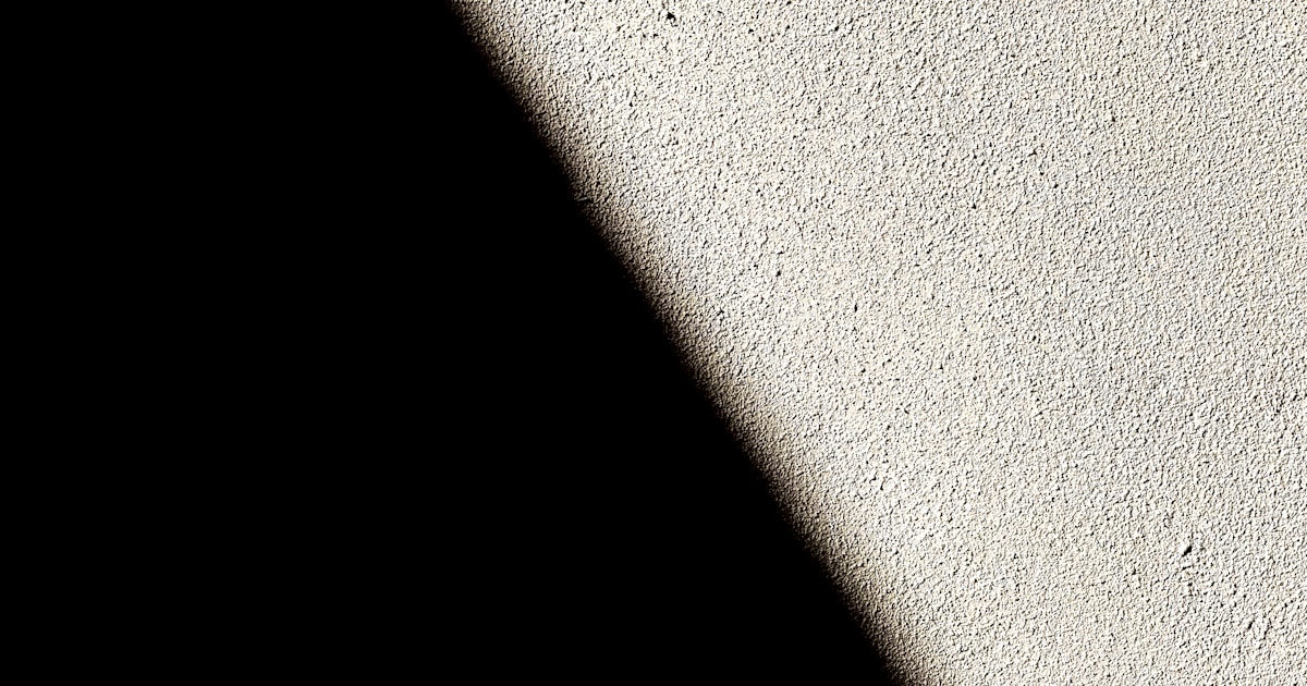 a black and white photo of a clock on a wall