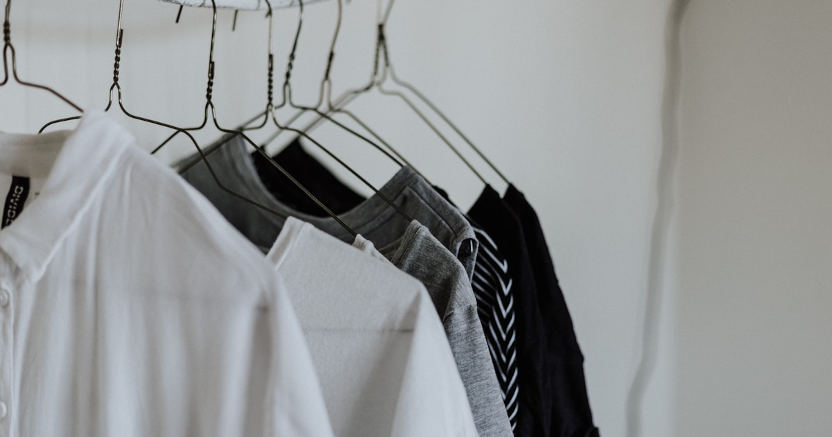 assorted-color shirt hanging beside wall