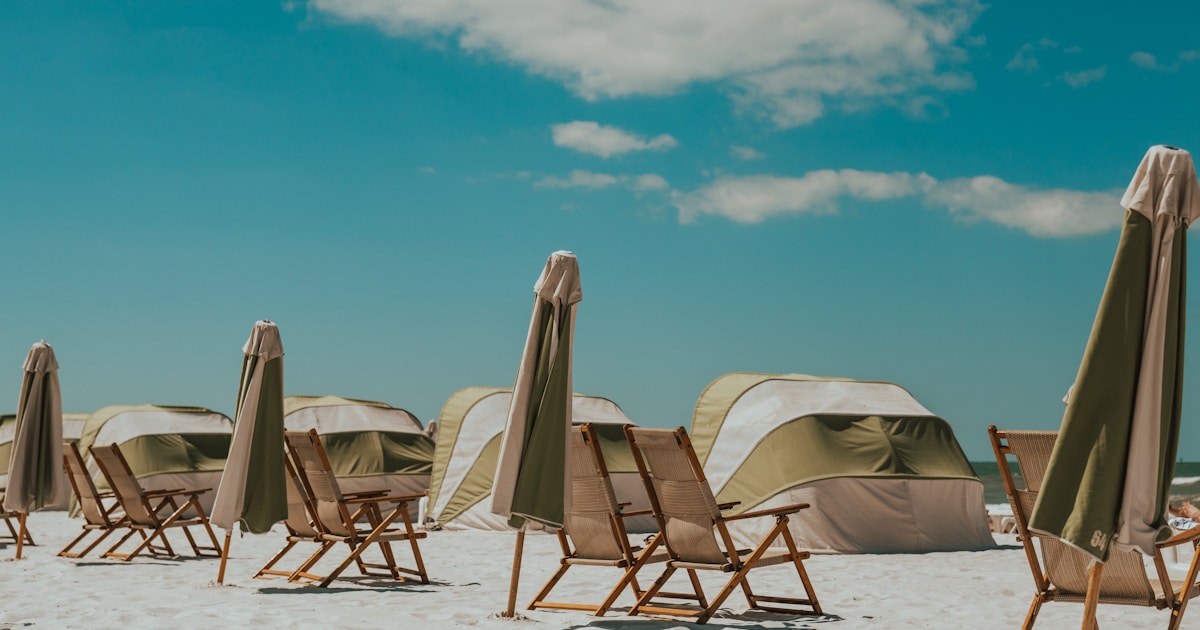 brown beach loungers with parasols lot