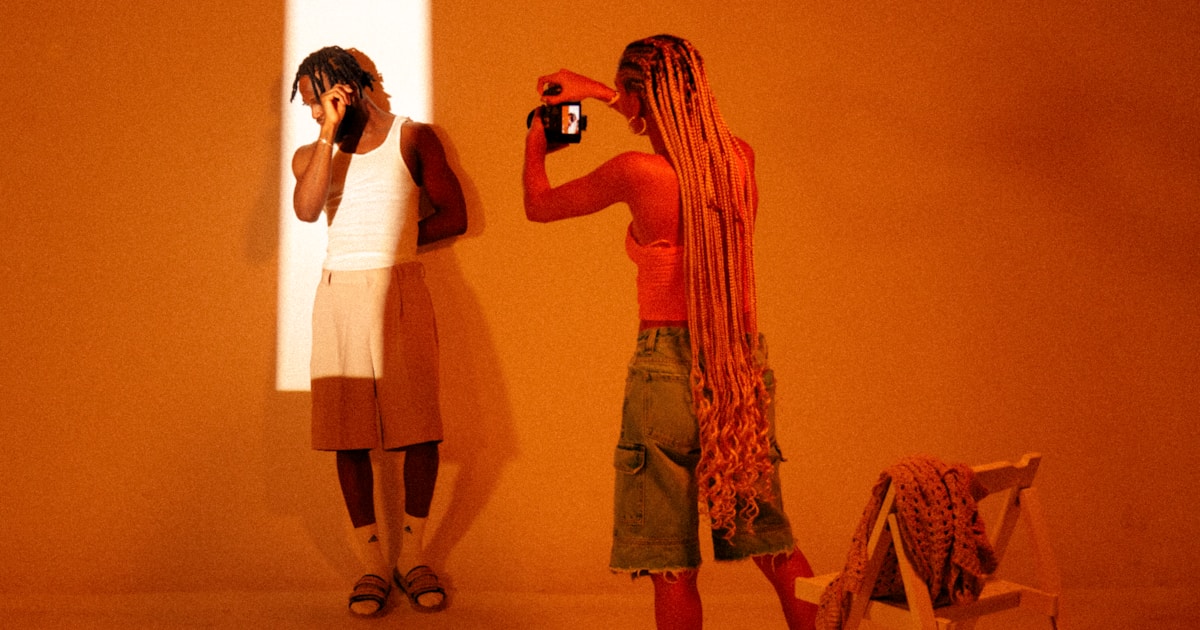 a woman taking a picture of herself in a mirror