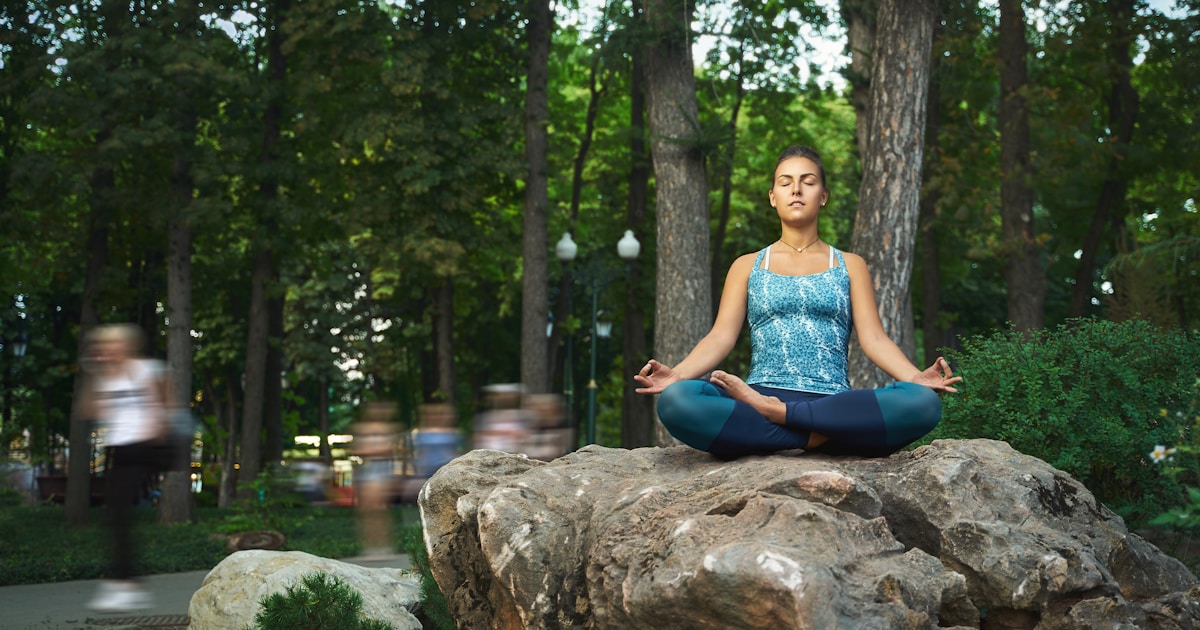 a person sitting on a rock