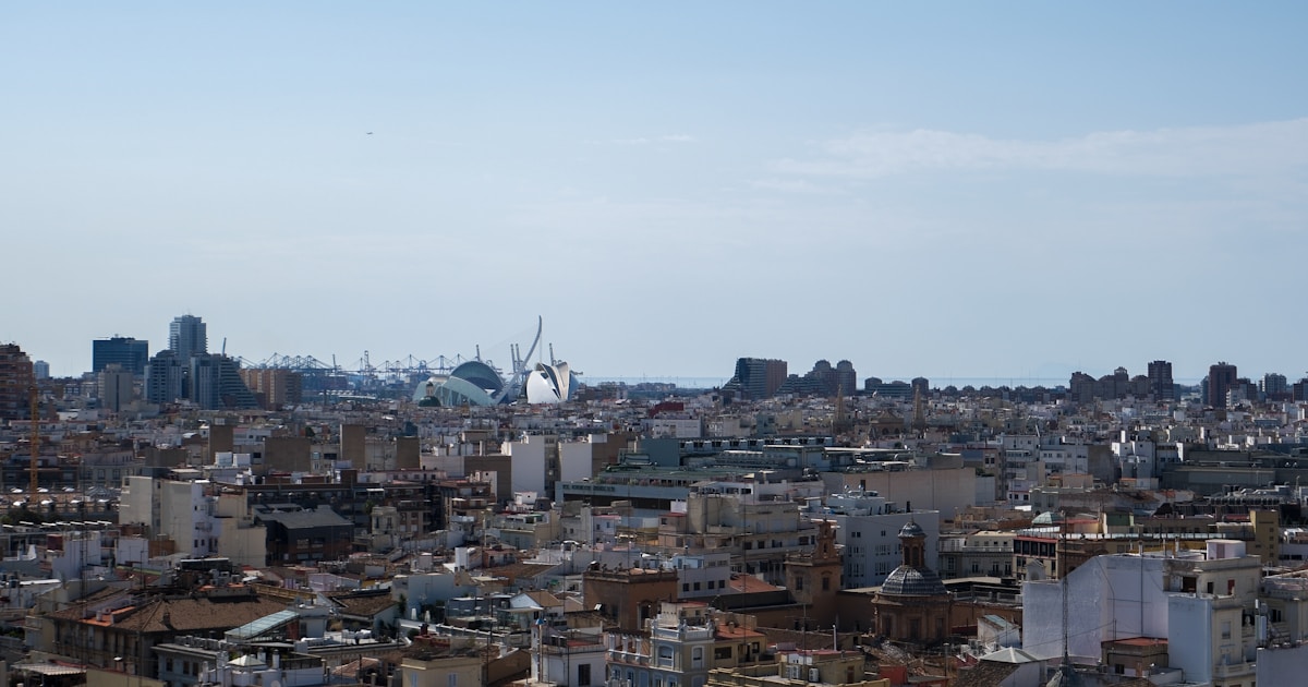 An expansive cityscape under a bright blue sky.