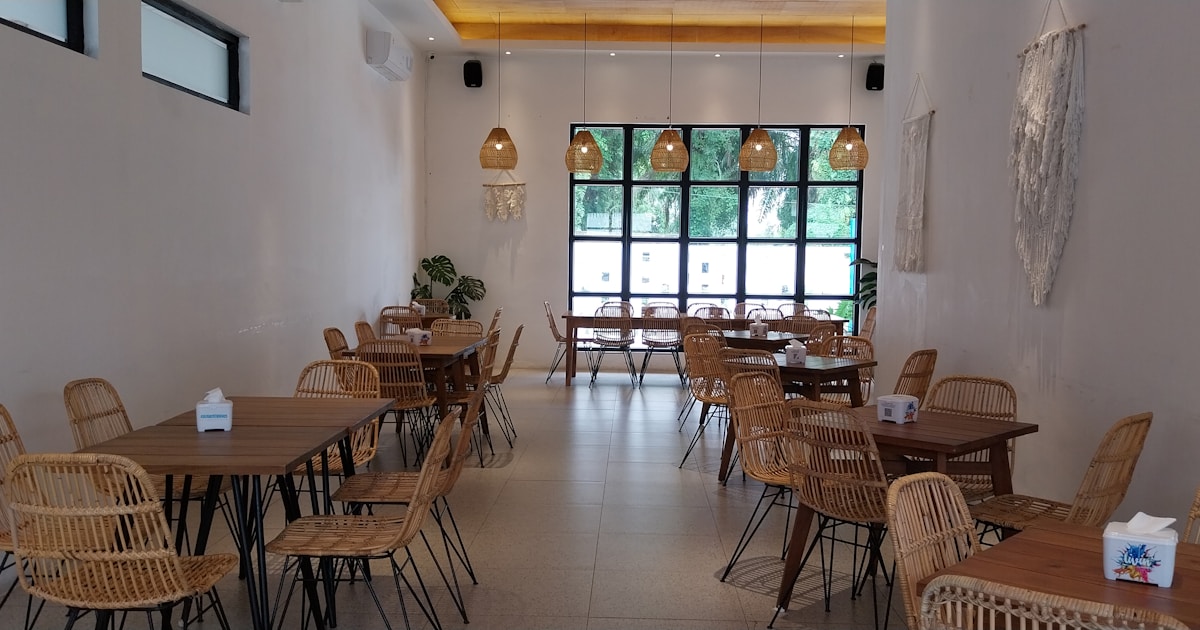 a restaurant with wicker tables and chairs