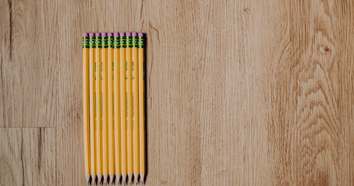 Sharpened #2 pencils laying on a wood floor