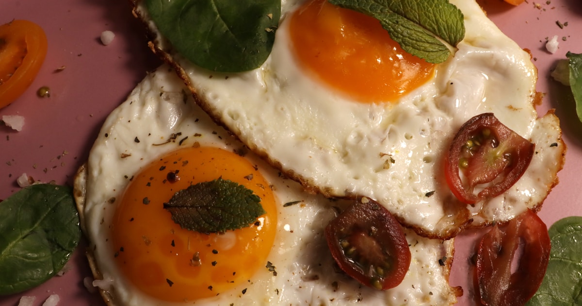 Fried eggs with fresh herbs and tomatoes.
