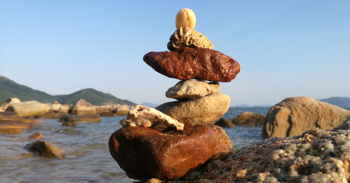 a stack of rocks sitting on top of a rocky beach