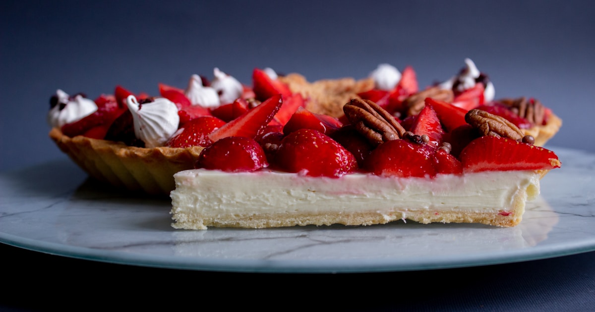 a piece of pie with strawberries and pecans on top